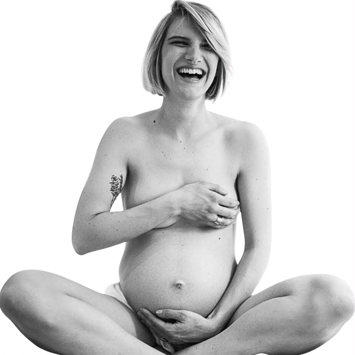Joyful expectant mother laughing